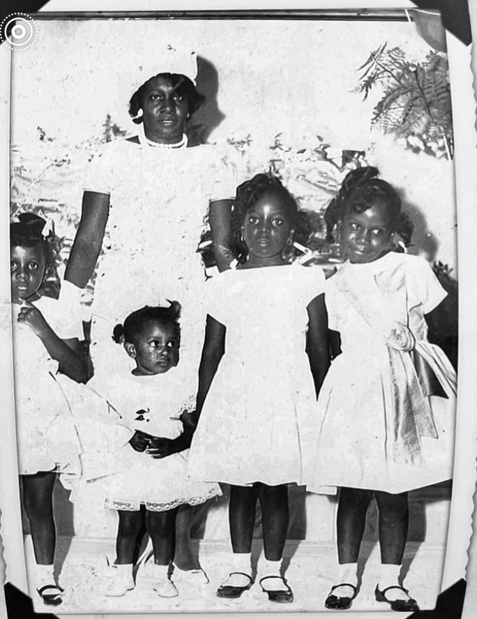 Damaged black and white portrait of mother and children before restoration